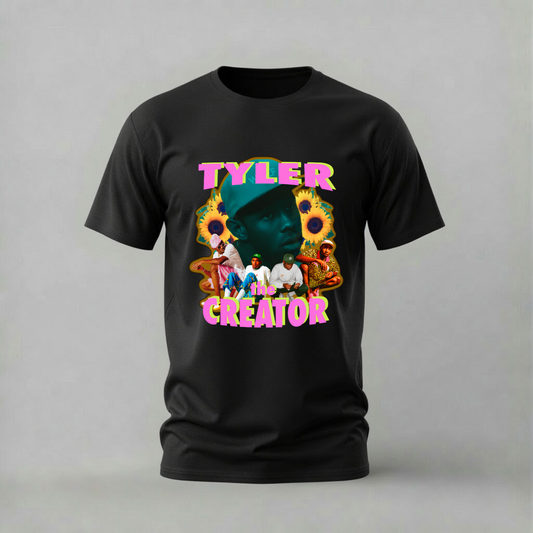 A black short-sleeve crewneck t-shirt featuring a colorful graphic print on the front with the text 'TYLER CREATOR' in pink, yellow, and blue, alongside a stylized portrait and sunflower illustrations, shown against a neutral gray background.