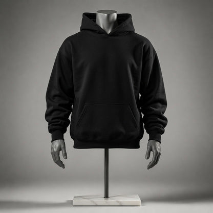 A black pullover hoodie displayed on a mannequin torso with hands and a stand against a smooth gray studio background.