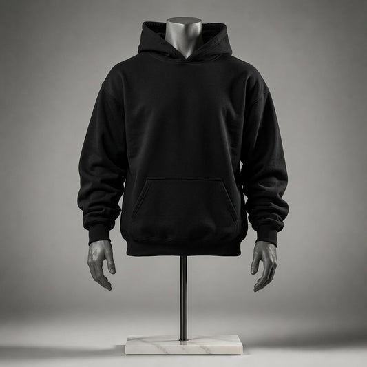 A black pullover hoodie displayed on a mannequin torso with hands and a stand against a smooth gray studio background.