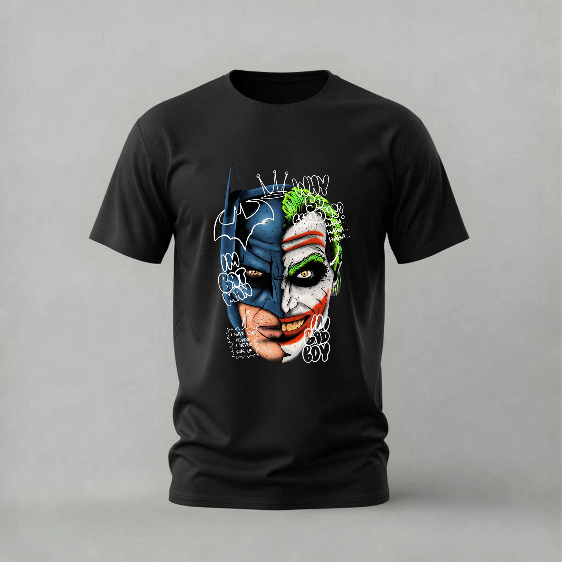 A black short-sleeve crewneck t-shirt featuring a graphic print of Batman and the Joker merged together, with 'BATMAN JOKER' text and comic-style doodles, shown against a neutral gray background.