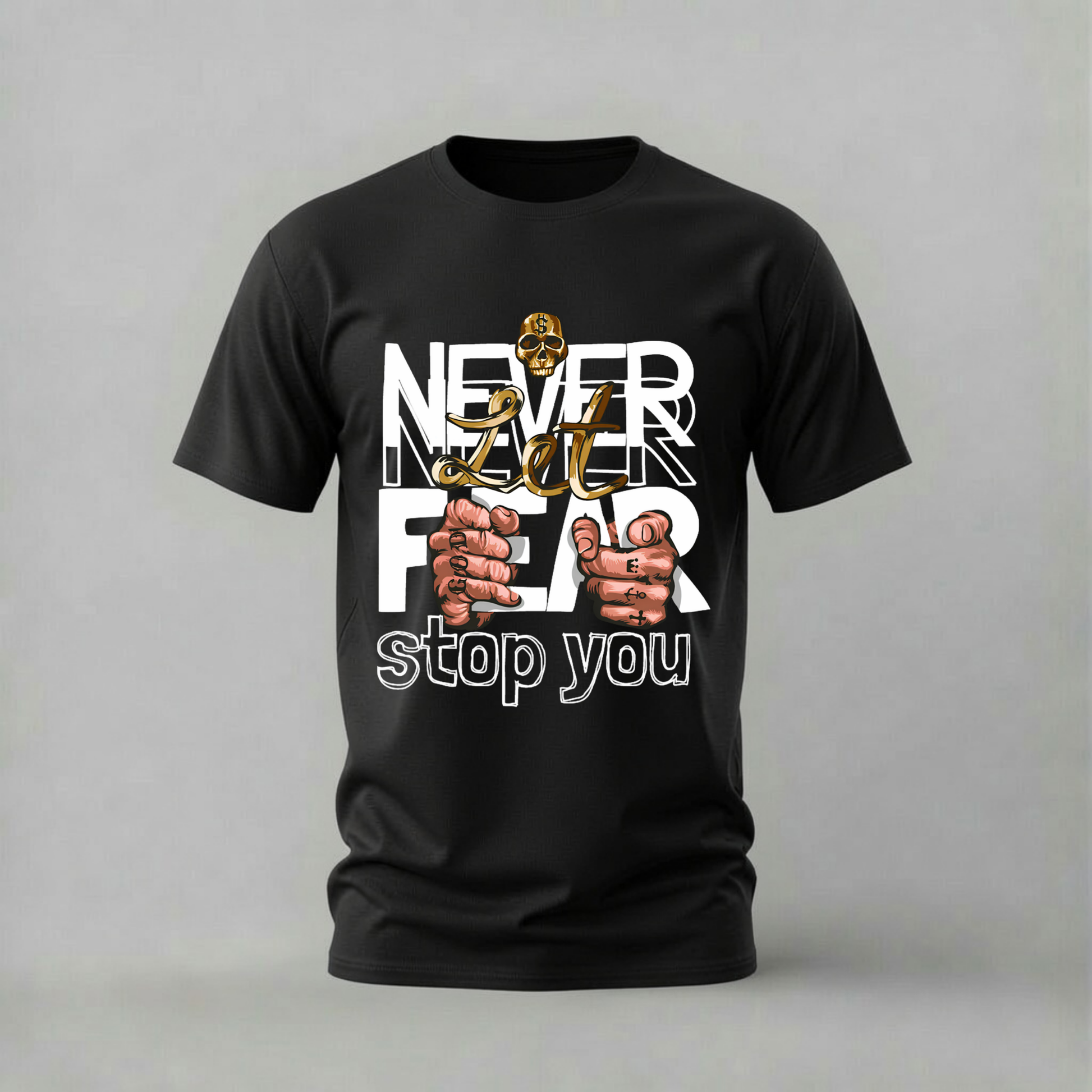 A black short-sleeve graphic t-shirt displayed on a neutral gray background. The front of the shirt features a bold white text design reading 'NEVER FEAR stop you' with a gold skull and two illustrated fists gripping the letters.