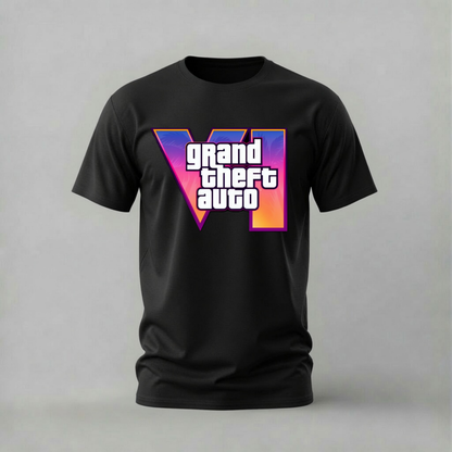A black short-sleeve t-shirt featuring a large 'VI' graphic with the text 'grand theft auto' in white, set against a purple, pink, and orange gradient background, displayed on a neutral gray studio backdrop.