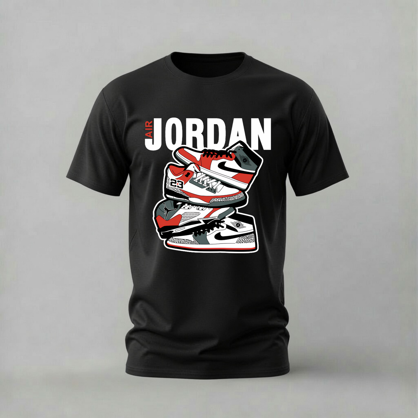 A black short-sleeve t-shirt with a graphic print of three red, white, and black sneakers stacked vertically under the text 'JORDAN' in bold white letters, displayed on a neutral gray background.