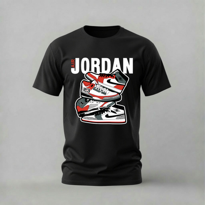 A black short-sleeve t-shirt with a graphic print of three red, white, and black sneakers stacked vertically under the text 'JORDAN' in bold white letters, displayed on a neutral gray background.