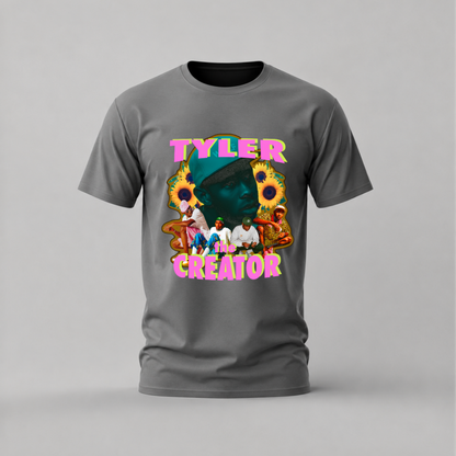 A dark gray crewneck t-shirt featuring a colorful graphic print on the front with the text 'TYLER CREATOR' in pink, yellow, and blue, alongside a collage of images including sunflowers and a green face.