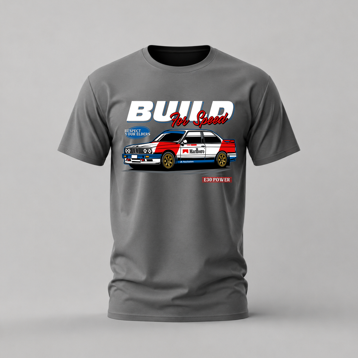 A dark gray crewneck t-shirt featuring a graphic print of a red, white, and blue classic race car with the text 'BUILD For Good' and 'E3 POWER' on a light gray background.