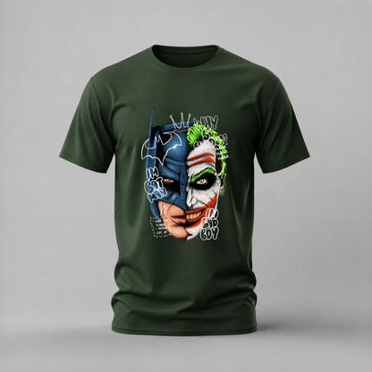 A dark green short-sleeve t-shirt with a graphic print of Batman and the Joker merged into one face, featuring graffiti-style text, shown on a neutral gray background.