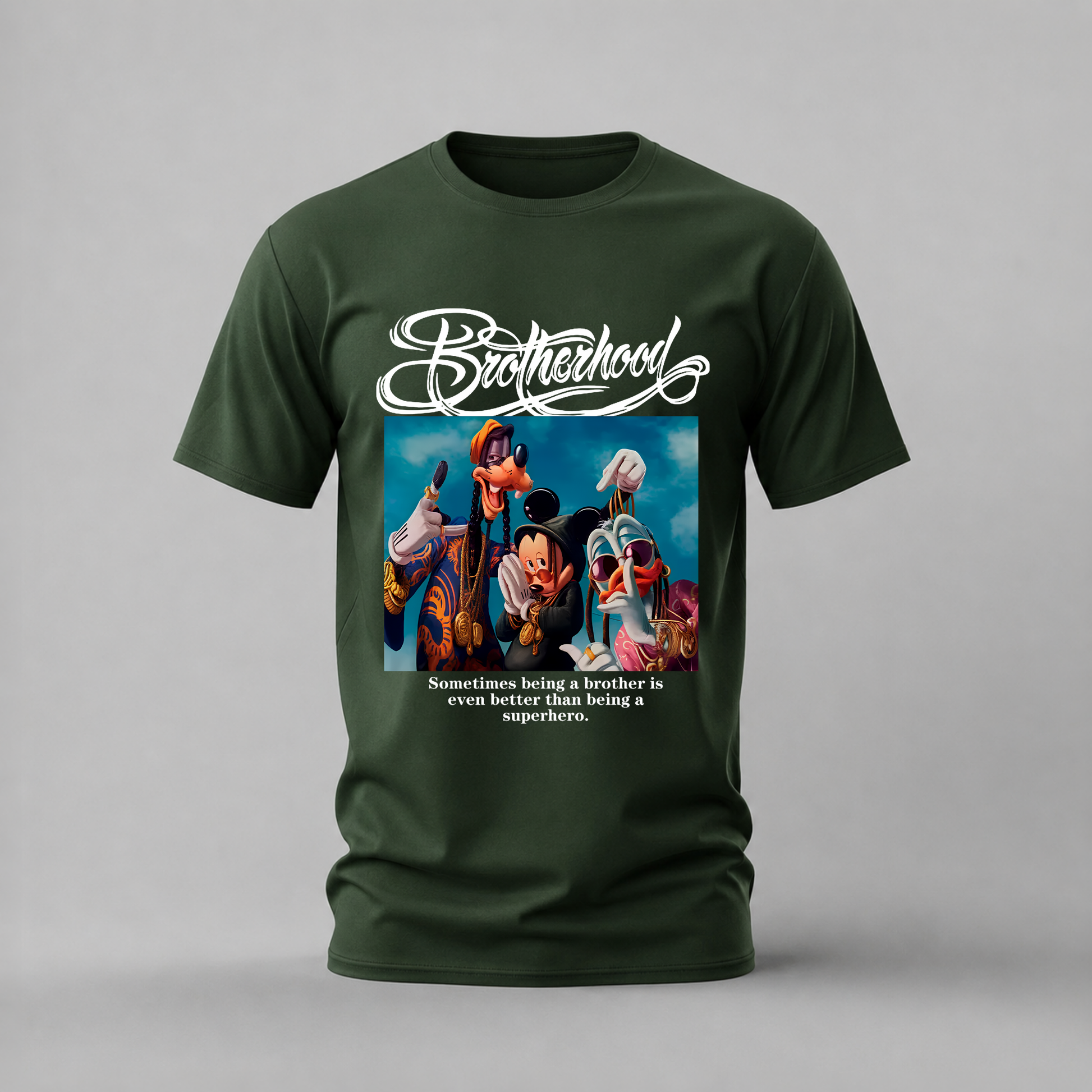 A dark green short-sleeve t-shirt with a graphic print on the front. The graphic features the word 'Brotherhood' in a white cursive font above a colorful illustration of Mickey Mouse and other Disney characters, with the text 'Sometimes being a brother is even better than being a superhero.