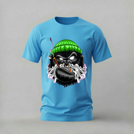 A light blue short-sleeve crewneck t-shirt featuring a graphic print of a cartoon gorilla wearing a green knit beanie and smoking a pipe, set against a plain gray background.
