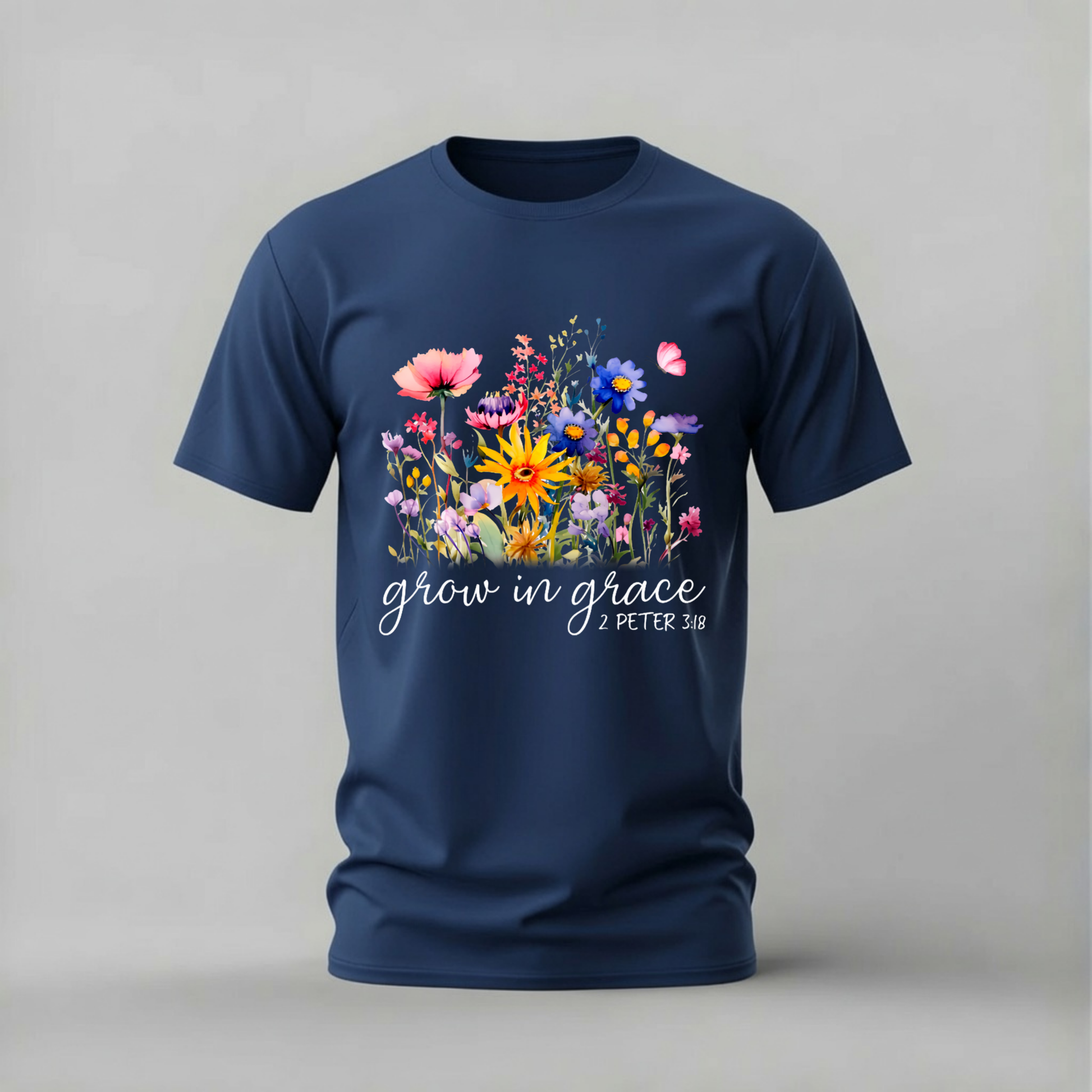 A navy blue short-sleeve crewneck t-shirt featuring a colorful floral graphic on the chest with the white script text 'grow in grace - PETER 3:18'.
