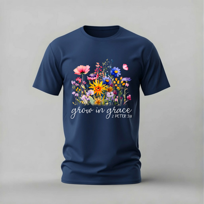 A navy blue short-sleeve crewneck t-shirt featuring a colorful floral graphic on the chest with the white script text 'grow in grace - PETER 3:18'.