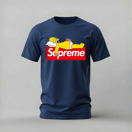 A navy blue short-sleeve t-shirt with a graphic print on the chest. The graphic features a cartoon character lying on a red box with the word 'Supreme' in white.