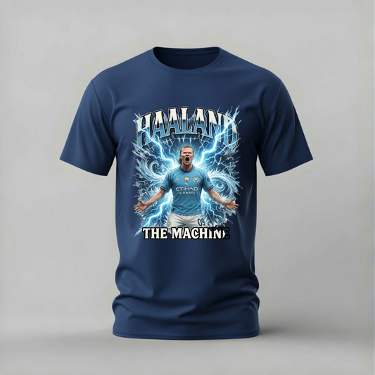 A navy blue short-sleeve t-shirt with a large graphic print of a soccer player surrounded by blue lightning effects and the text 'HAALAND' and 'THE MACHIN'.