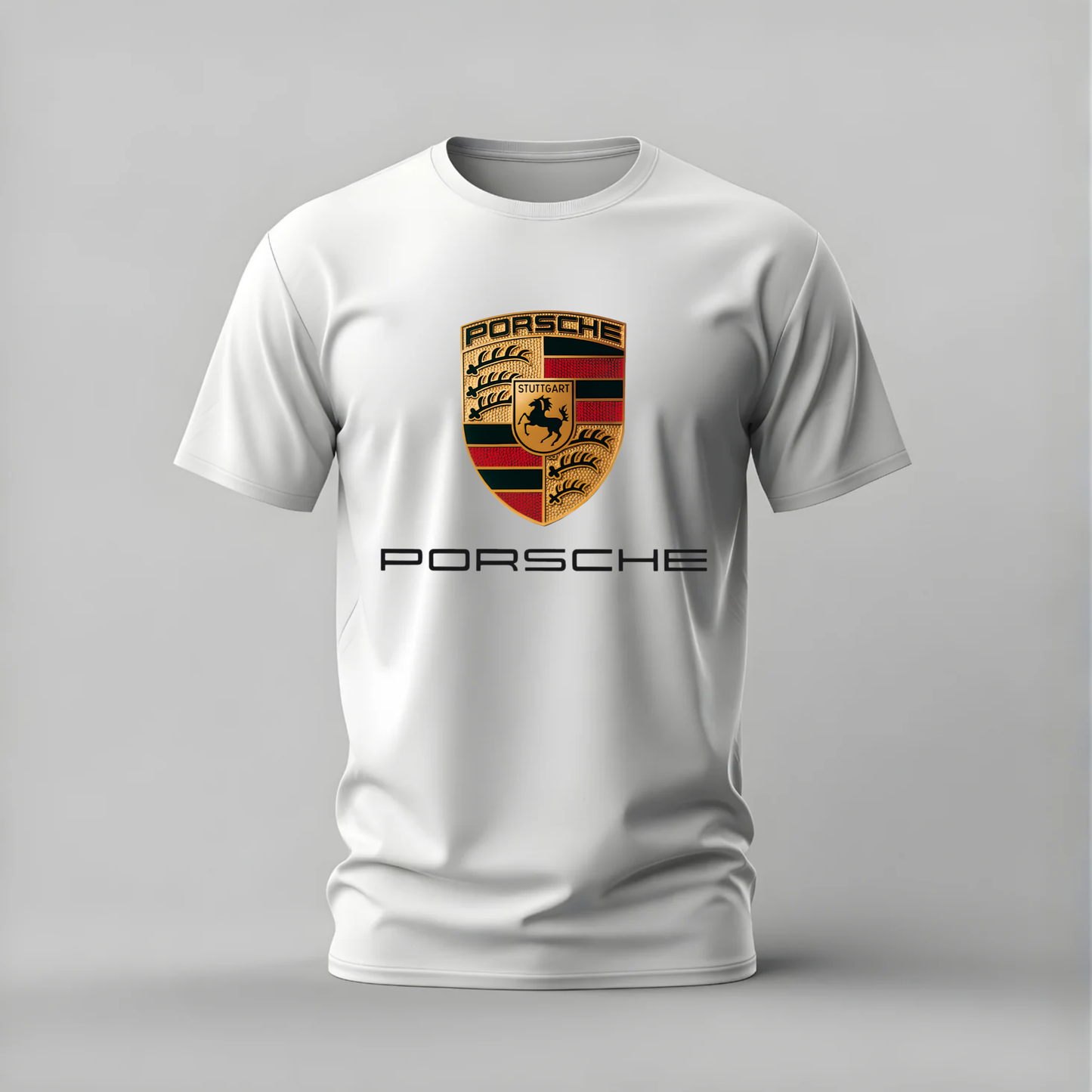 A white short-sleeve crewneck t-shirt featuring a gold, black, and red Porsche crest on the chest, with the word 'PORSCHE' printed in black underneath, shown against a neutral gray background.