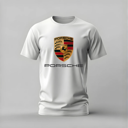 A white short-sleeve crewneck t-shirt featuring a gold, black, and red Porsche crest on the chest, with the word 'PORSCHE' printed in black underneath, shown against a neutral gray background.