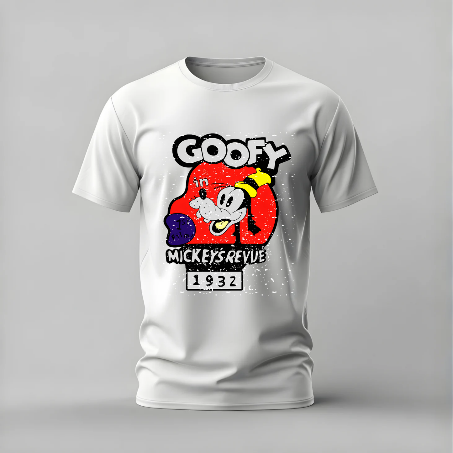 A white short-sleeve crewneck t-shirt featuring a retro graphic print of Goofy from Mickey Mouse's 1932 revue, displayed on a neutral gray background.