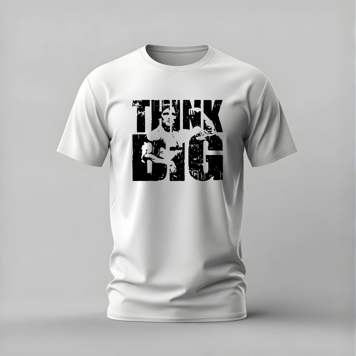 A white short-sleeve crewneck t-shirt with a distressed black graphic print on the front reading 'THINK BIG' with a portrait of Albert Einstein inside the letters, shown on a neutral gray background.