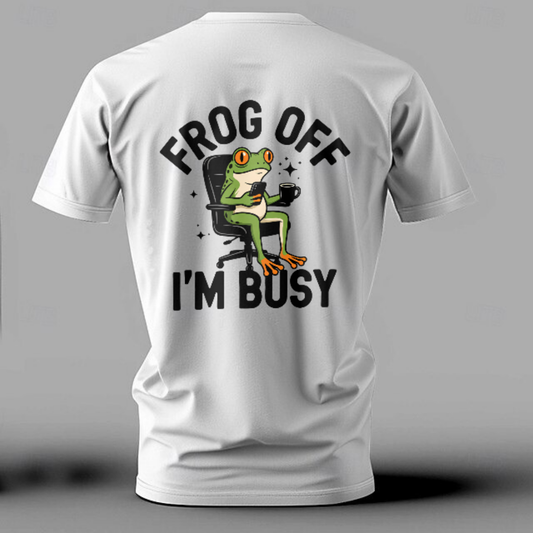 White t-shirt with a graphic of a frog and text 'Frog off, I'm busy' on a gray background